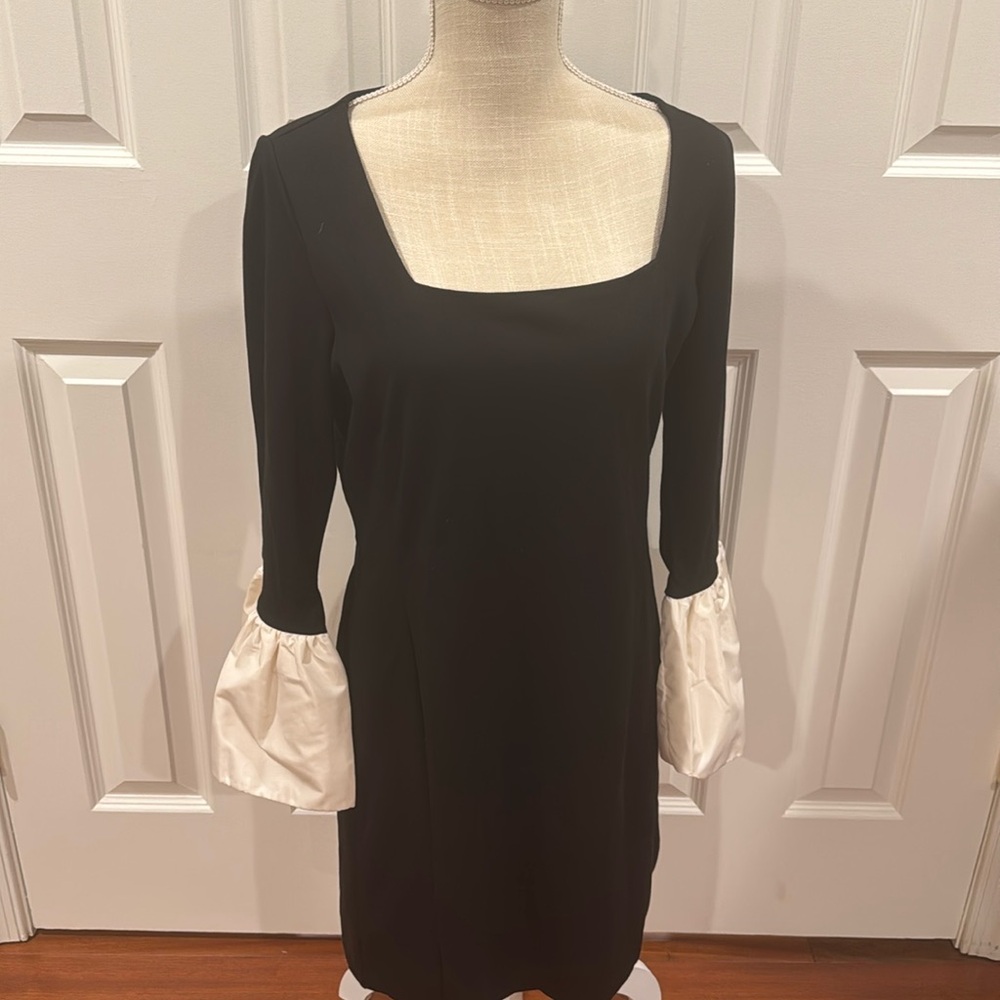 Square neck. Bracelet sleeves. Back zip. Lined body, unlined sleeves.